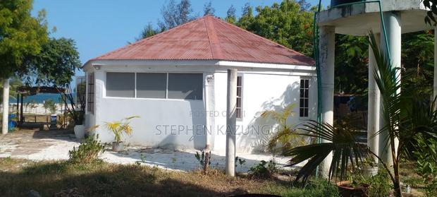 On Sale 1/2 Acre Beach Plot With House in It.