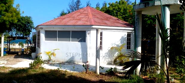 On Sale 1/2 Acre Beach Plot With House in It.