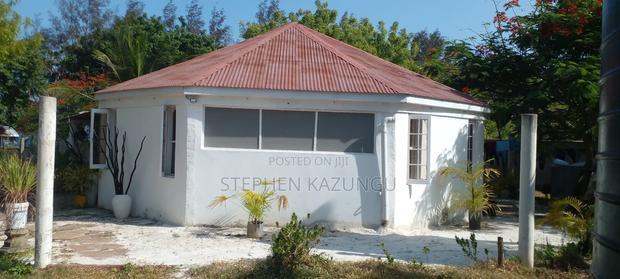 On Sale 1/2 Acre Beach Plot With House in It.