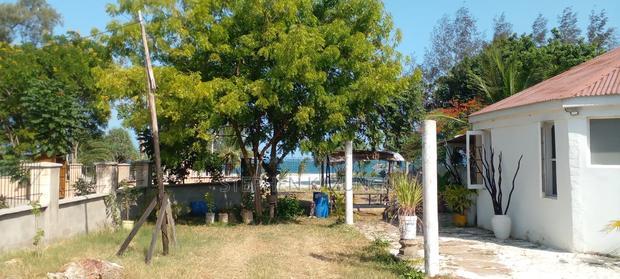 On Sale 1/2 Acre Beach Plot With House in It.